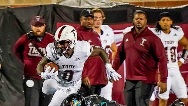 Troy Trojans running back Kimani Vidal (0) is tackled by Coastal Carolina Chanticleers linebacker Mason Shelton (20) at Brooks Stadium.